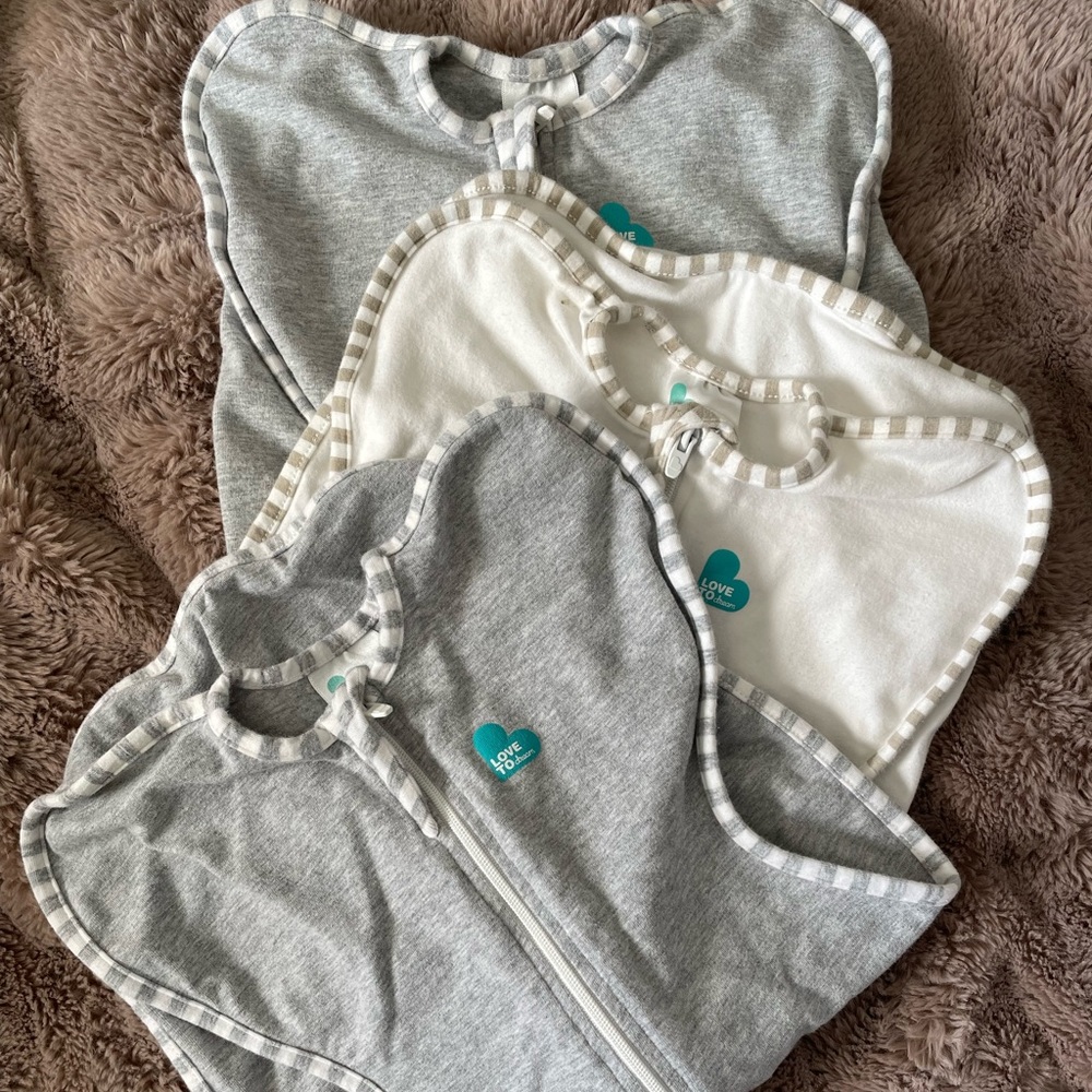 Love to dream swaddle up. Lot of 3 used swaddles. Two small &one newborn sized.